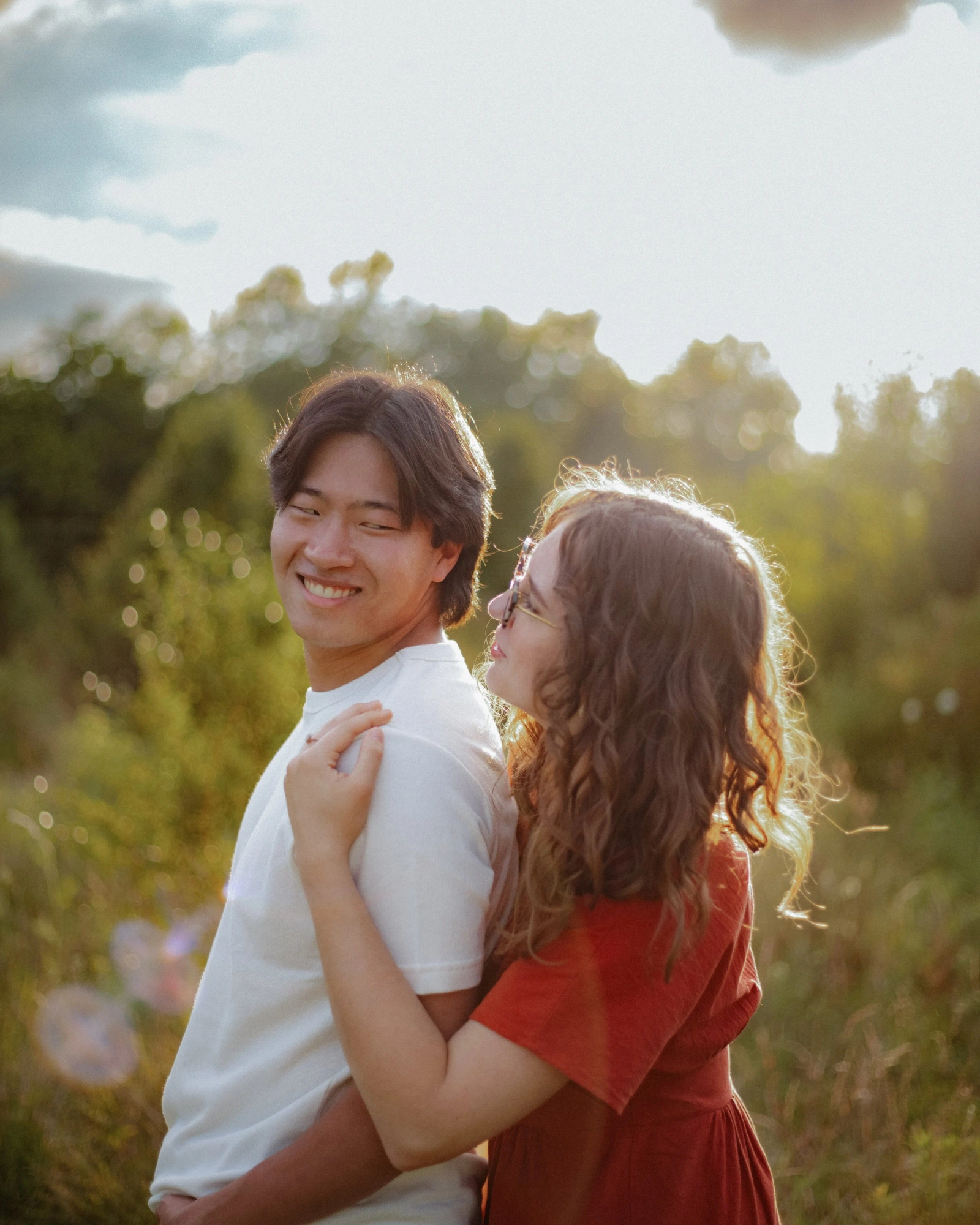 Couple dancing together in a sunlit field